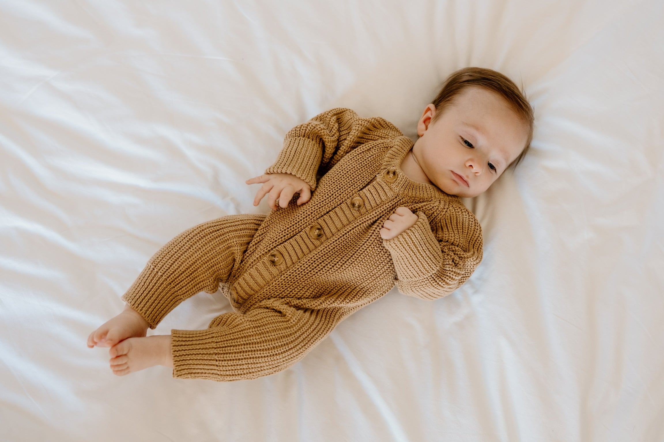Winnie + Crew comfortable and stylish onesies for newborns in modern, earth-tone colors
