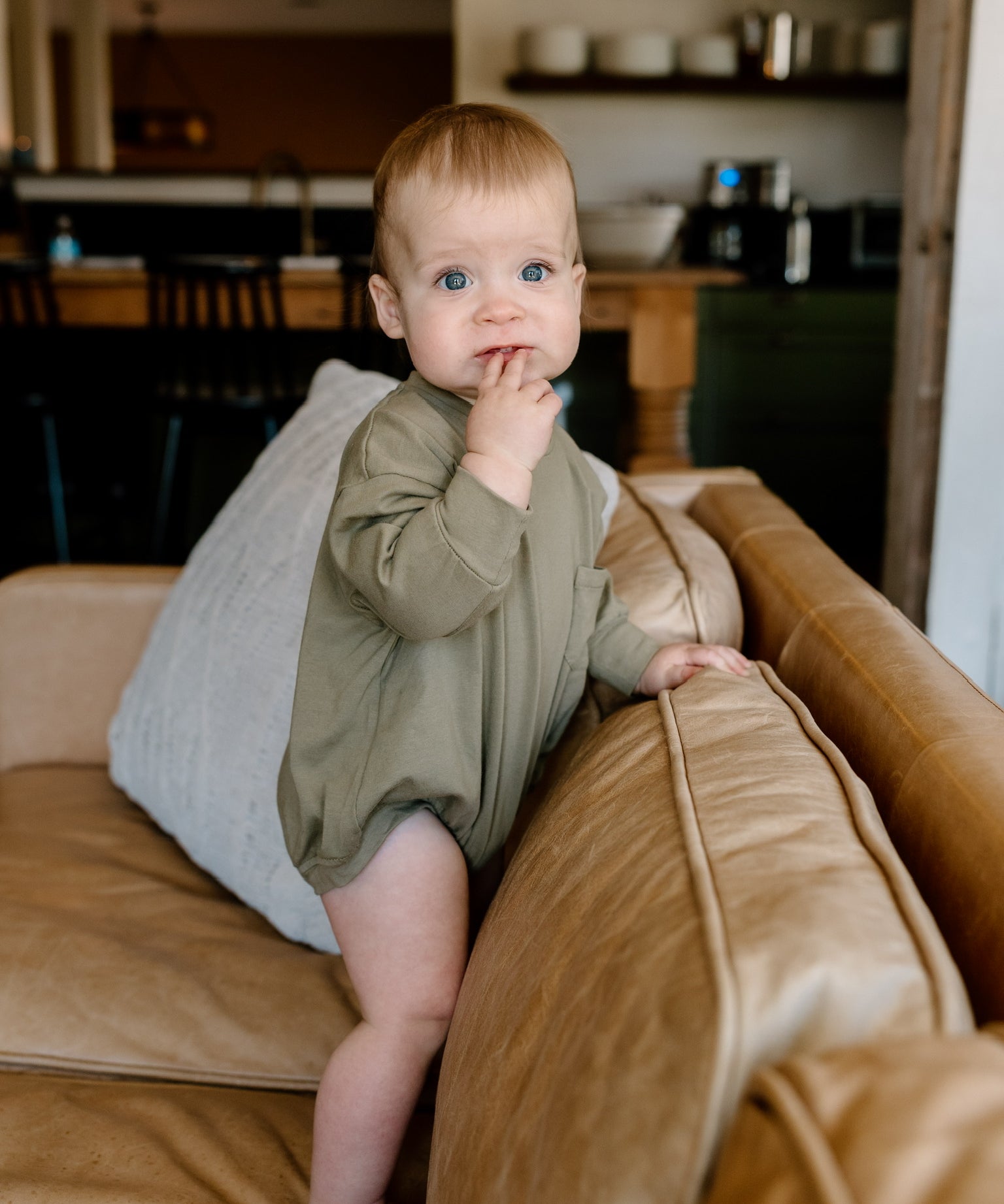 Winnie + Crew comfortable and stylish rompers for babies and toddlers in earthy green color